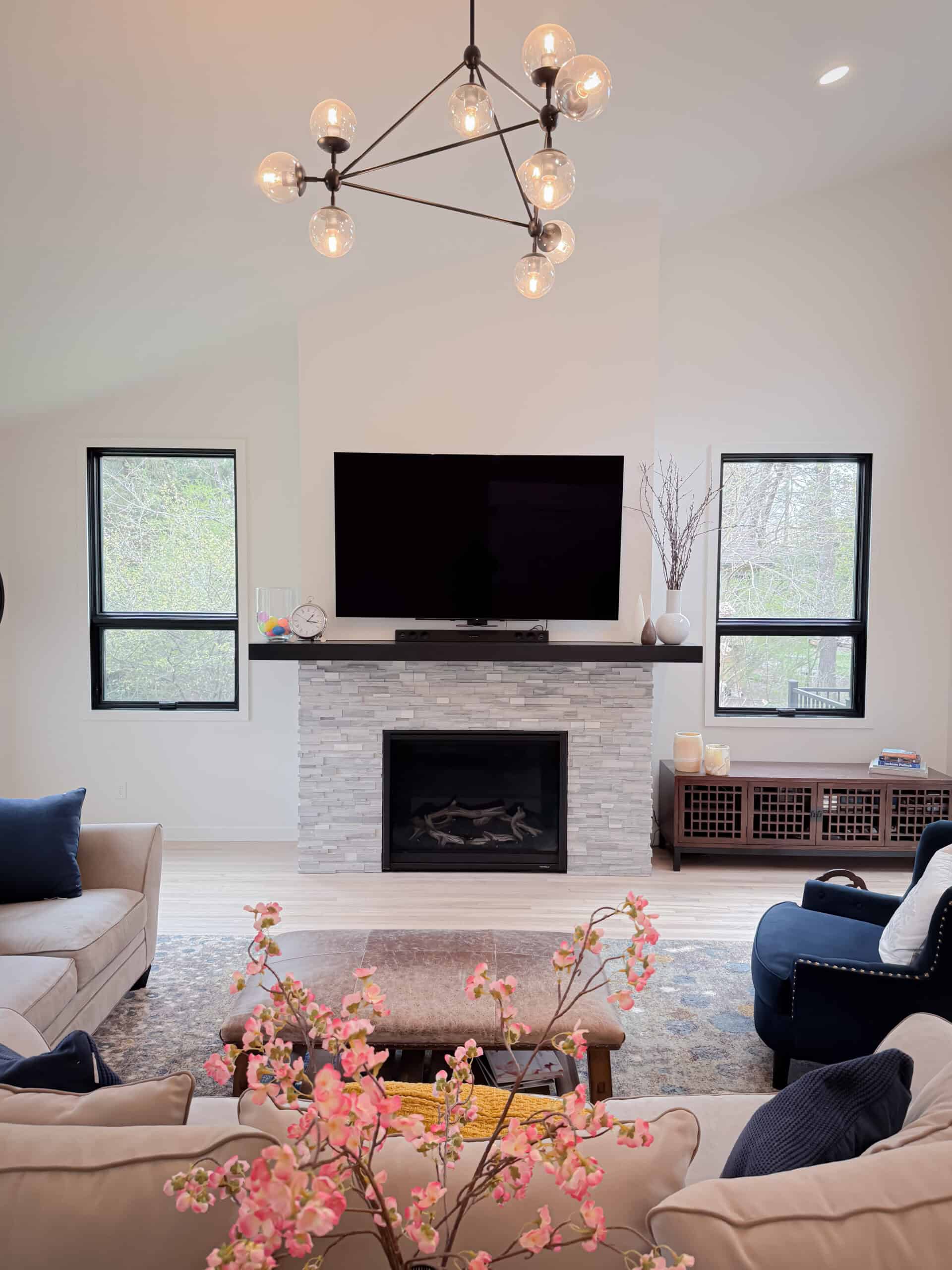 A living room with a fireplace and a television.