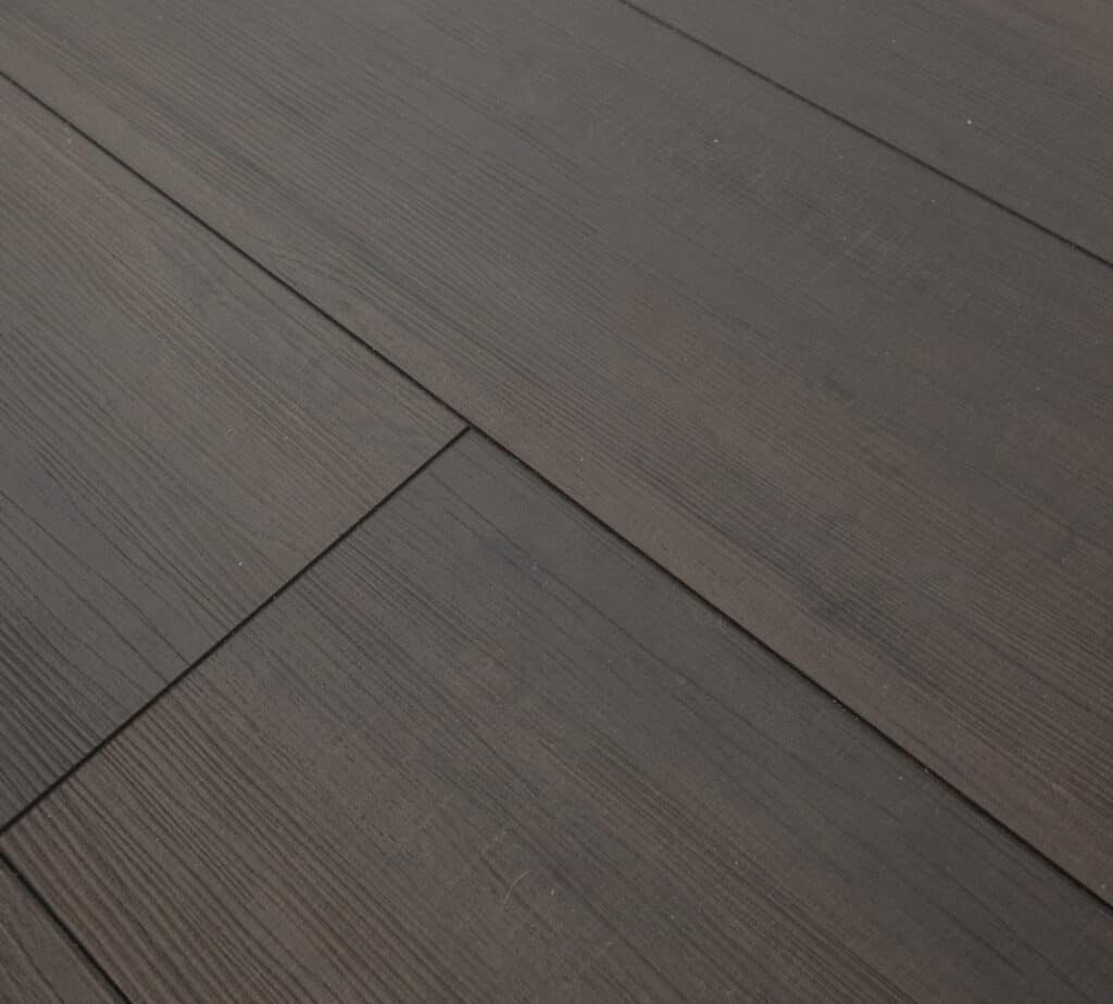 Close-up view of dark brown wooden floor panels with visible grain texture, aligned horizontally and diagonally across the image.