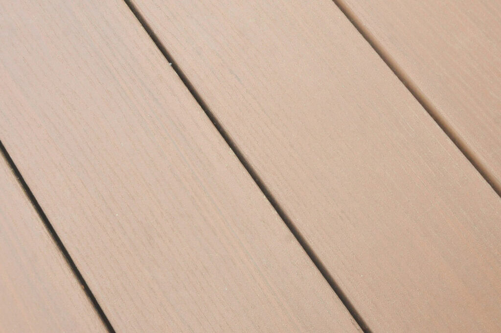 Close-up view of light brown wooden planks arranged side by side, showing the grain and texture of the wood.