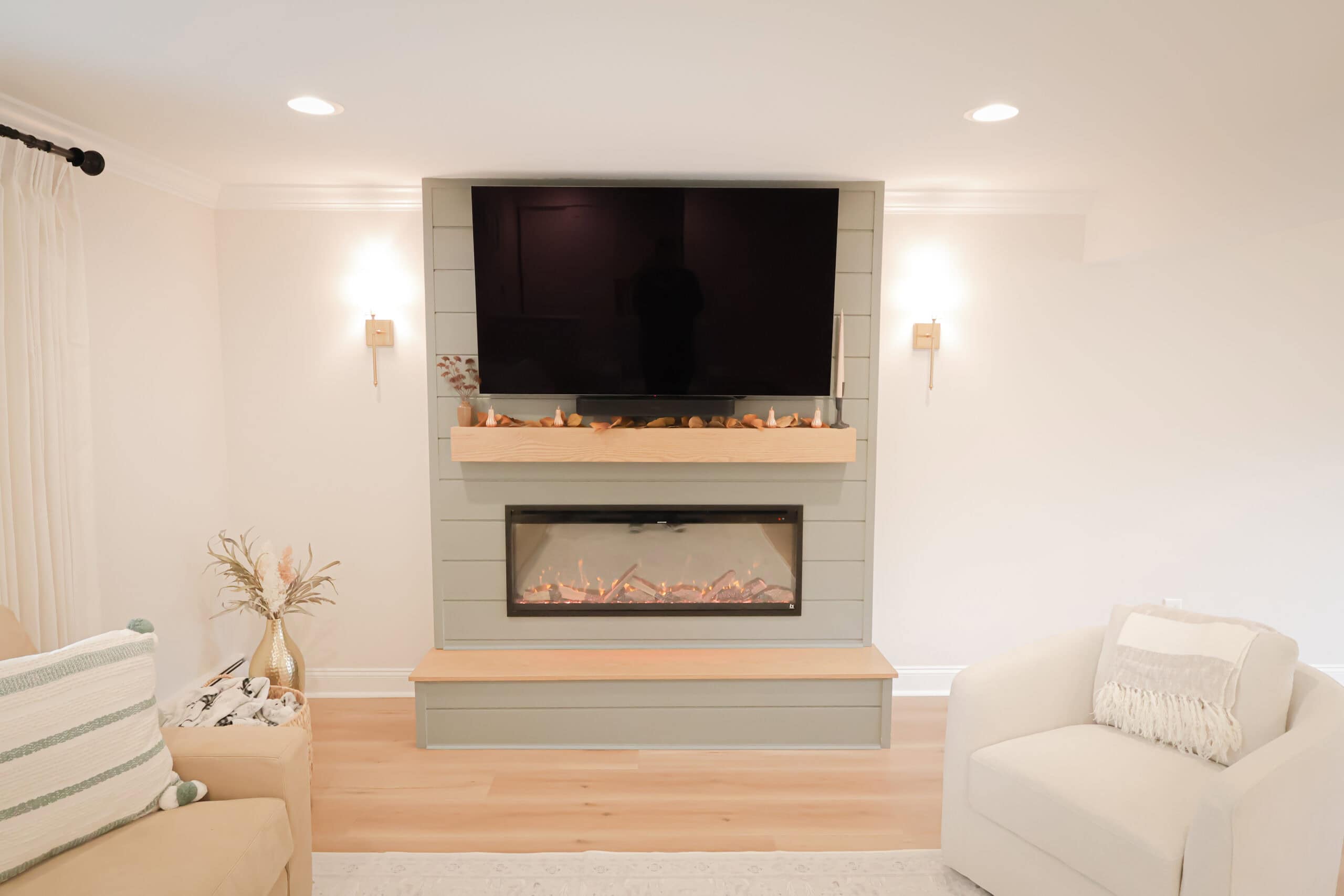 A fireplace with a tv above it.