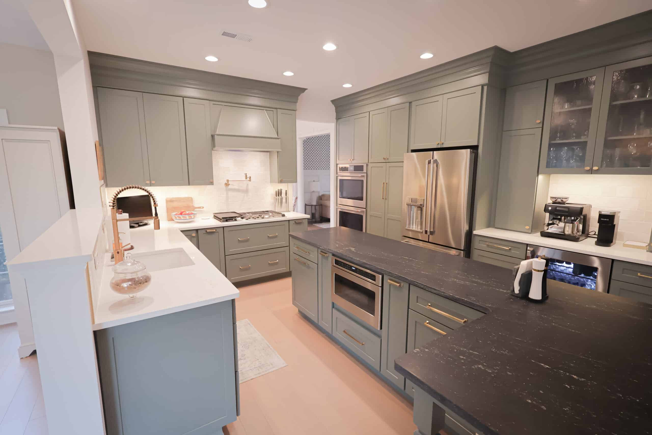 A kitchen remodel with grey cabinets and black countertops creates a modern, sophisticated space.