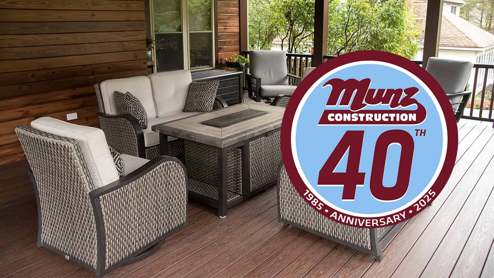 Modern outdoor deck addition built by Munz Construction with comfortable seating and summer landscaping