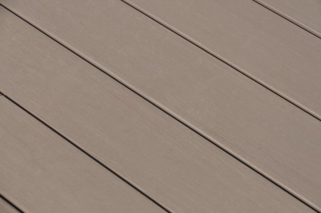 Close-up view of several light brown wooden planks arranged side by side, showing their smooth surface and slight wood grain texture.