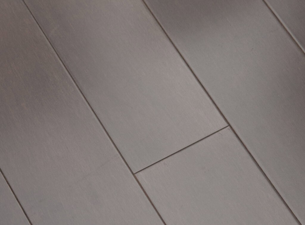 Close-up of several dark brown wooden floorboards, neatly arranged side by side with visible seams between the planks, showcasing a smooth, polished finish.