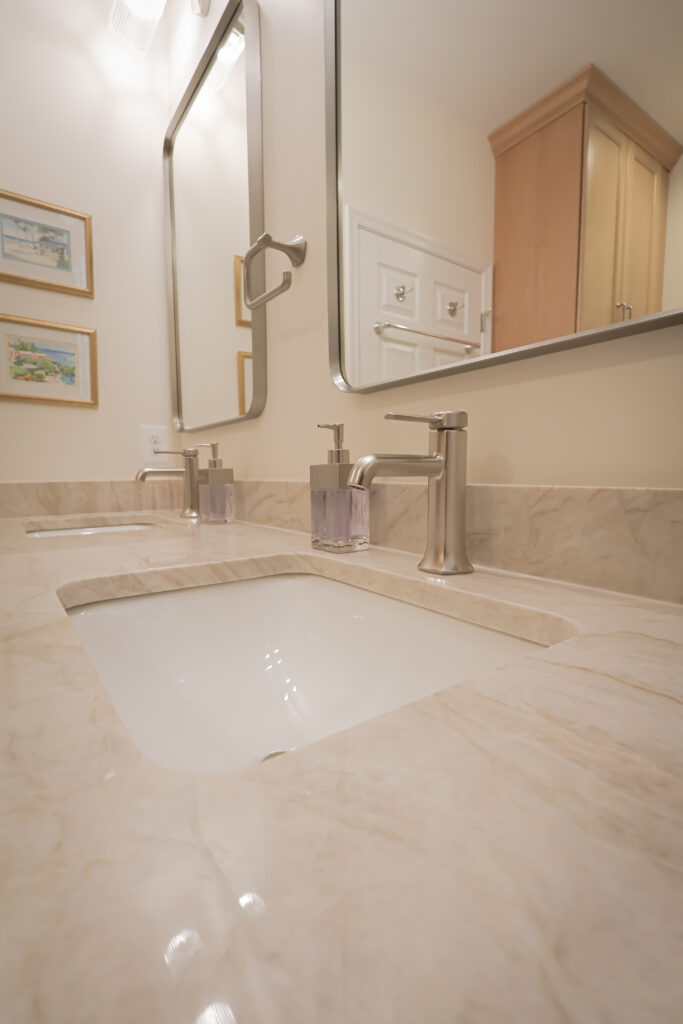 Bathroom vanity with marble countertop and contemporary fixtures.