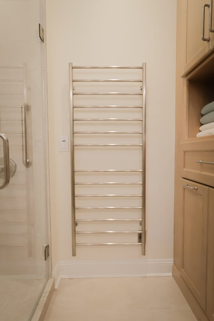 Heated towel rack installed in a bathroom for luxury and convenience.