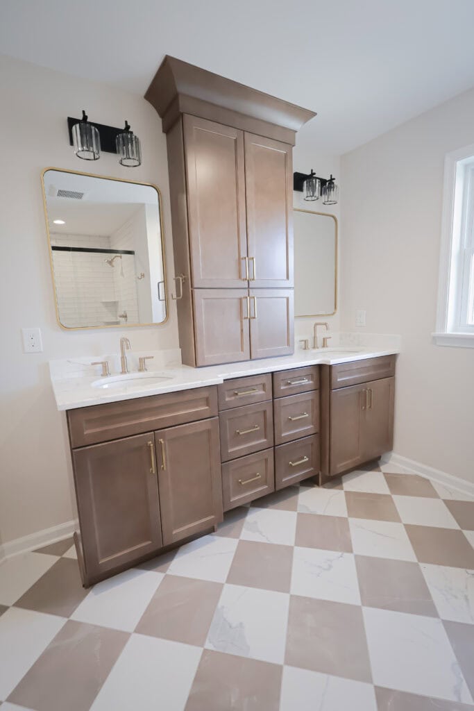 Bathroom vanity with double sinks, cabinetry, and mirrors in a contemporary bathroom.