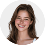 A young woman with long brown hair smiles at the camera. She is wearing a white top and has a natural, fresh-faced look. The background is plain and light-colored.