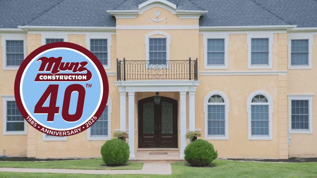 A large beige house with arched windows and a balcony. Overlaid on the left is a circular Munz Construction 40th Anniversary 1985-2025 badge in red, blue, and white—the perfect inspiration for how to avoid renovation regrets.