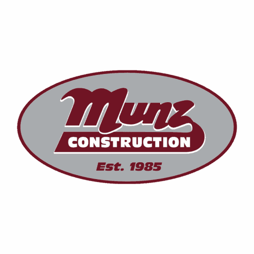 Logo for Munz Construction. The text Munz appears in cursive maroon letters above a maroon rectangle with CONSTRUCTION in white. Below, Est. 1985 is written in maroon. All text is inside a gray oval with a maroon outline.