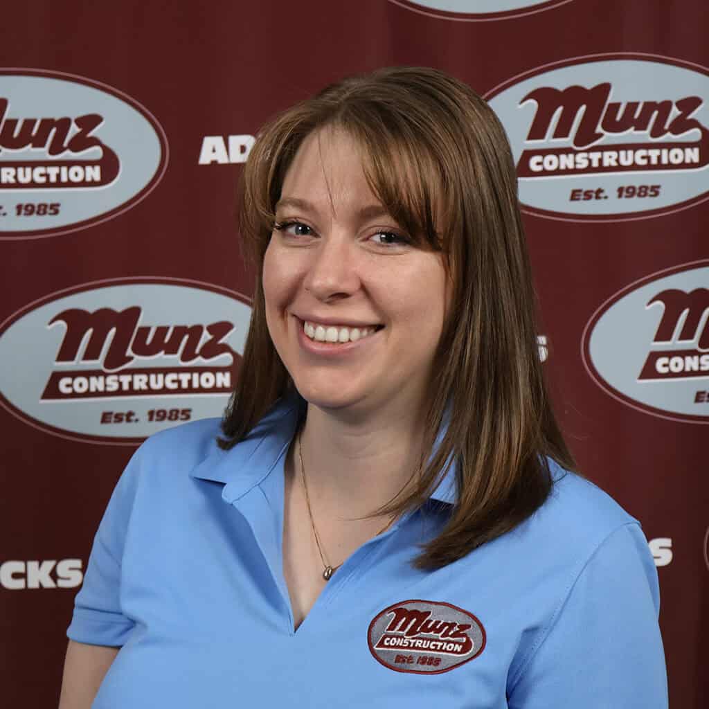 Female team member smiling at Munz Construction office.