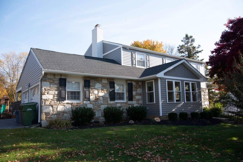 Residential home with new roofing and siding by Munz Construction.