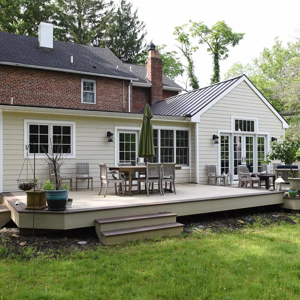Home addition with a spacious deck and outdoor seating area by Munz Construction.