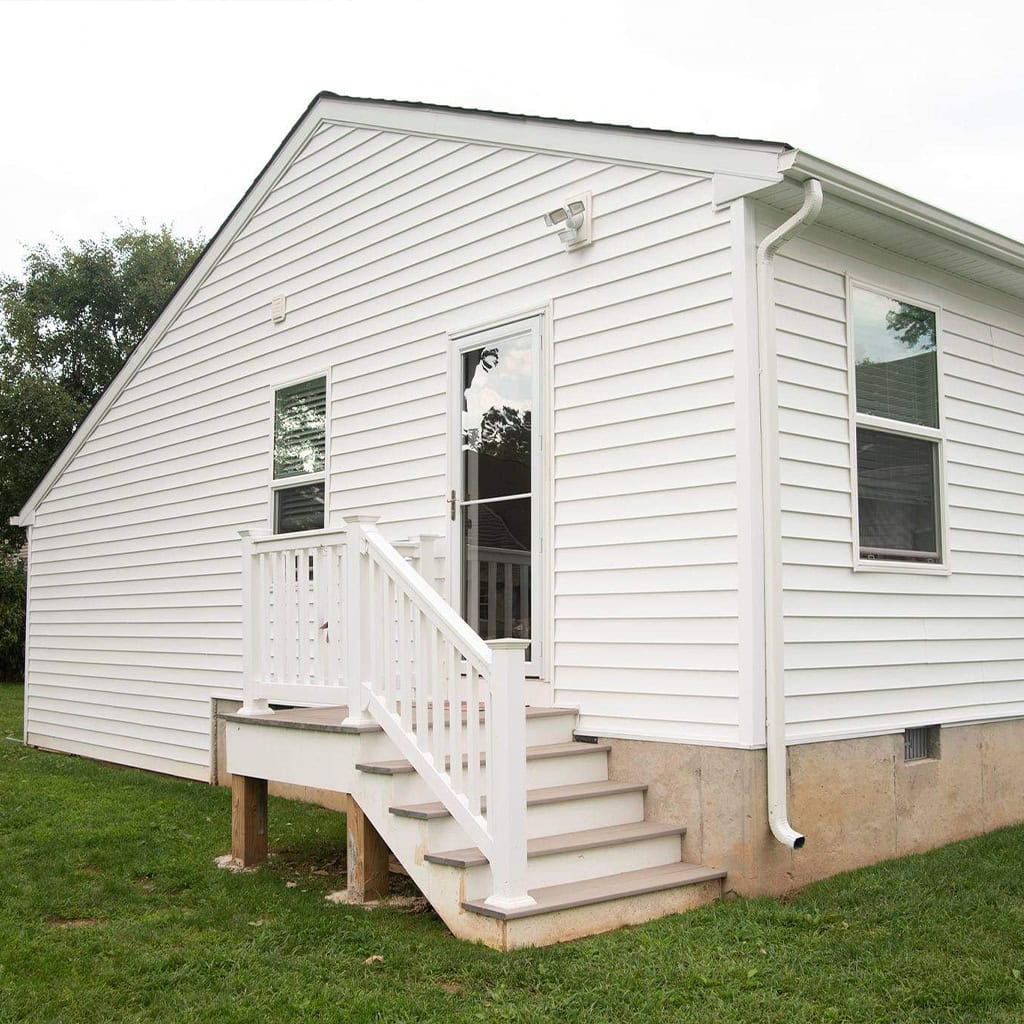 White in-law suite with stairs and sliding door, residential construction.