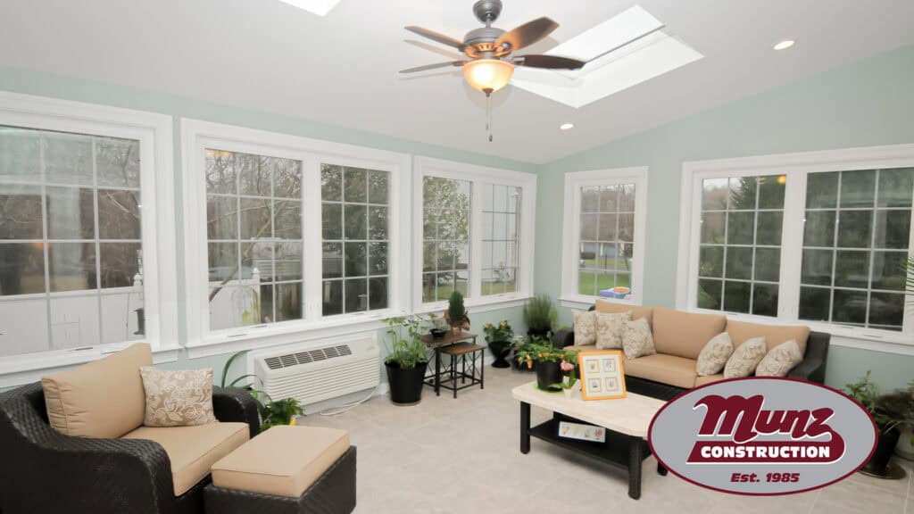 Bright sunroom with large windows, cozy seating, and indoor plants for a relaxing atmosphere.