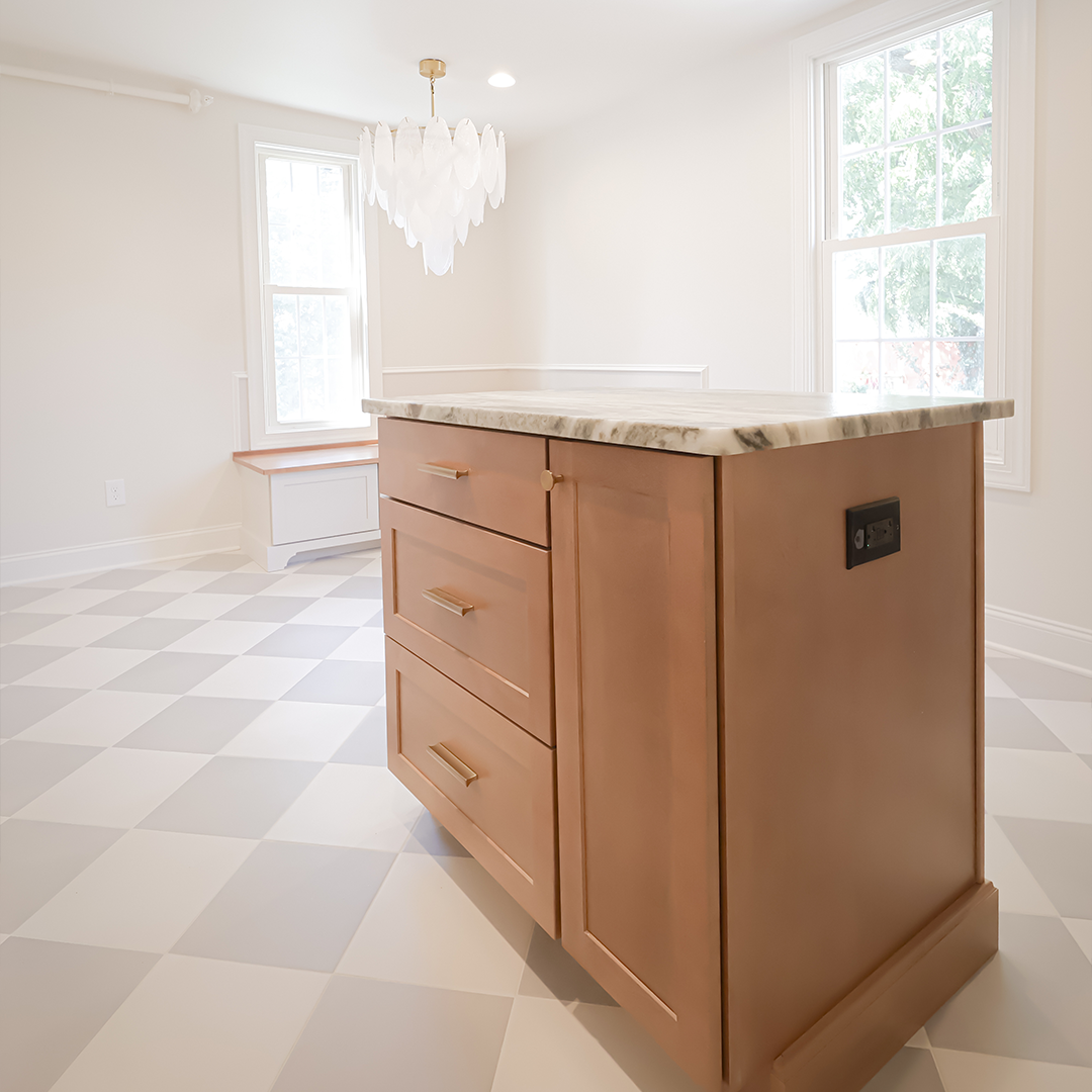 a modern kitchen with a marble topped island, light wood drawers, large windows, checkered floor tiles, and a white pendant light. natural light fills the bright, minimalist space. a modern kitchen with a marble topped island, light wood drawers, large windows, checkered floor tiles, and a white pendant light. natural light fills the bright, minimalist space.