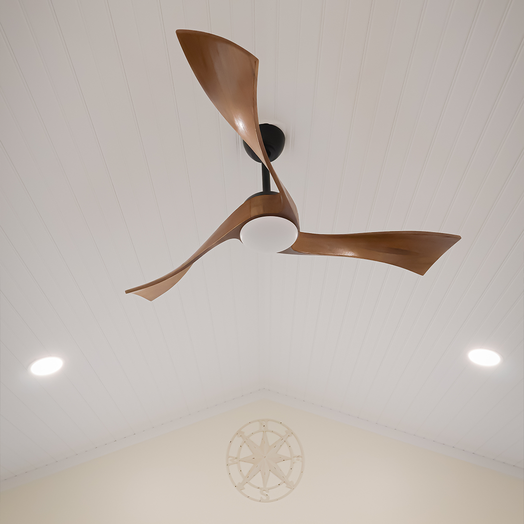 a modern ceiling fan with three curved wooden blades is mounted on a white paneled ceiling, flanked by two recessed lights. a decorative compass design is visible on the wall below. a modern ceiling fan with three curved wooden blades is mounted on a white paneled ceiling, flanked by two recessed lights. a decorative compass design is visible on the wall below.